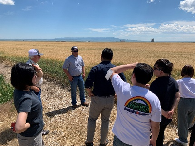 South Korea trade team listening to farmer about wheat