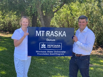 Lola Raska receiving her test plot sign